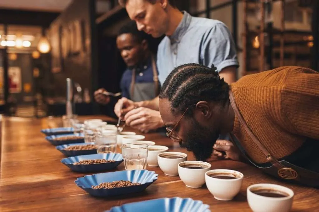 Three men cupping different coffees