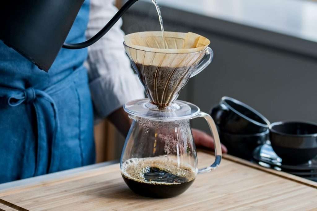 Home barista making pour-over coffee