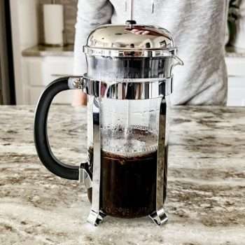 Home barista learning how to make French press coffee
