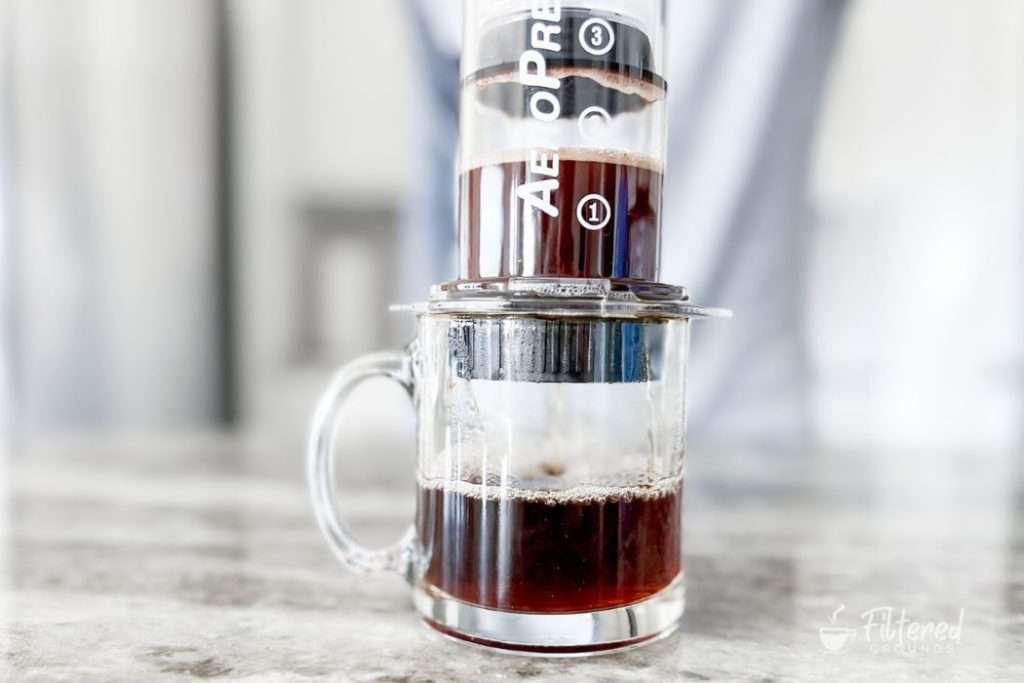 Coffee being brewed into a coffee mug using an AeroPress
